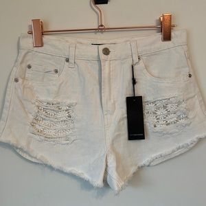 New with tags white jean shorts with daisy embellishment